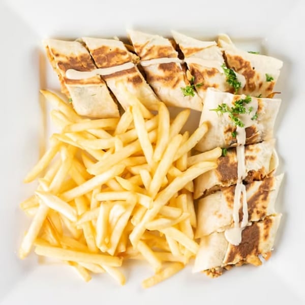 Jasmine Grill and Kabab's chicken shawarma wraps, drizzled with sauce and served with golden fries.